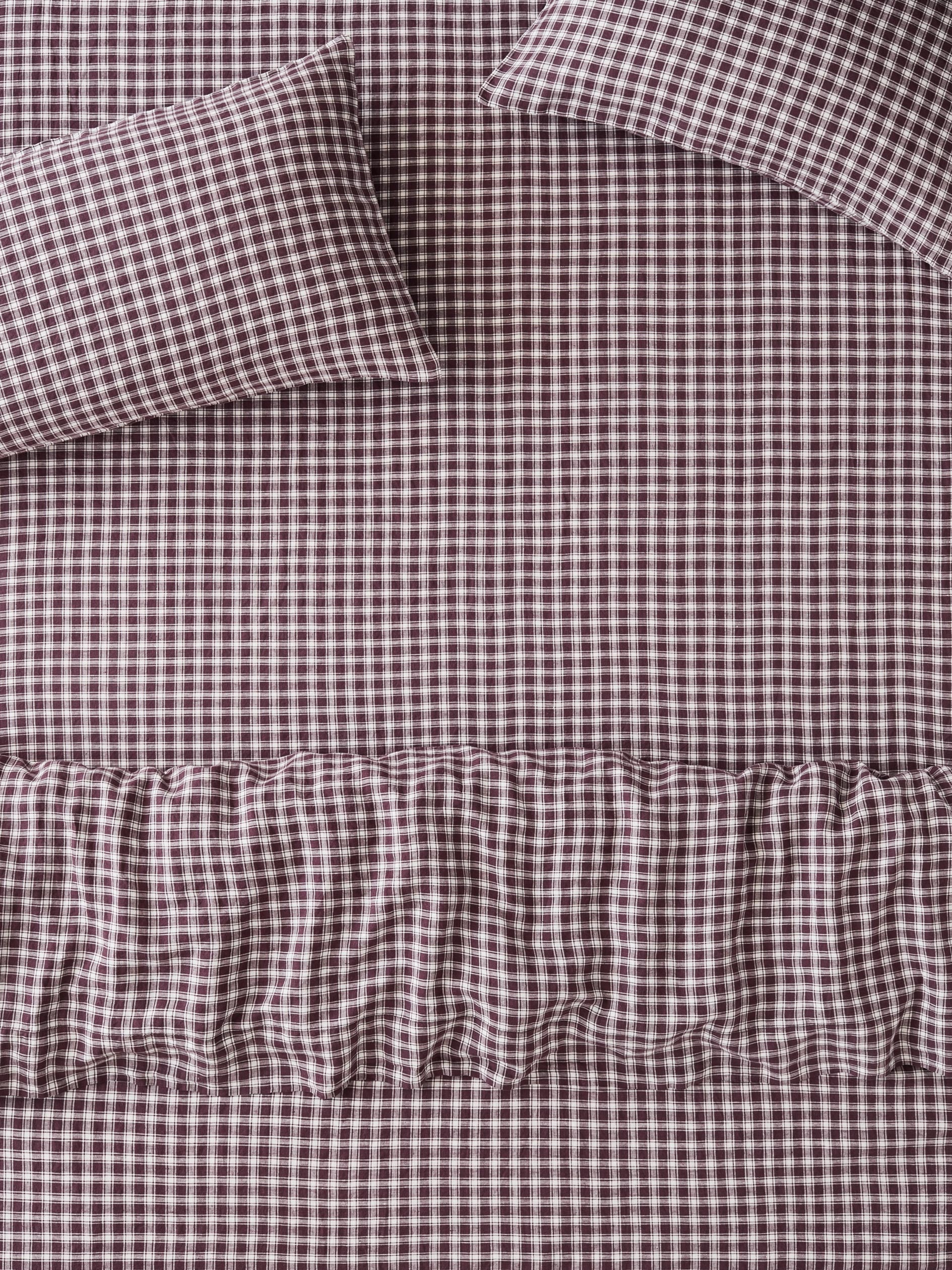 Brown and white gingham check bedding set including a sheet, pillowcase, and ruffled duvet cover.