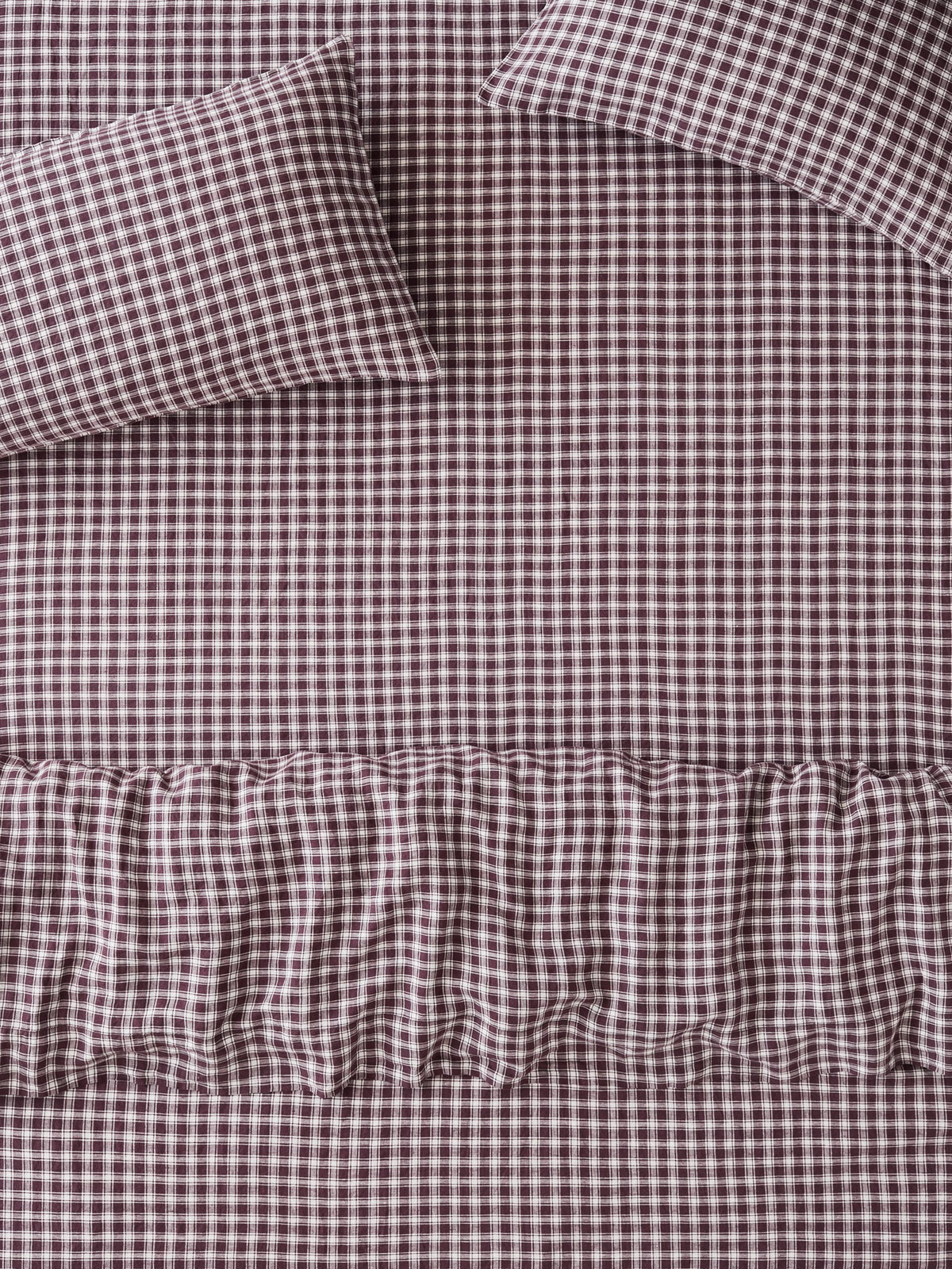 Brown and white gingham check bedding set including a sheet, pillowcase, and ruffled duvet cover.