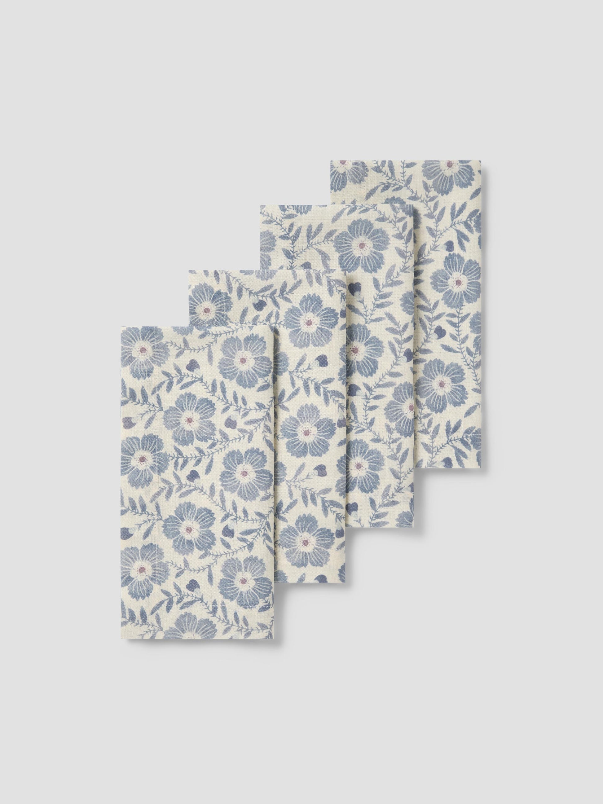 Set of three floral-patterned napkins on a light gray background
