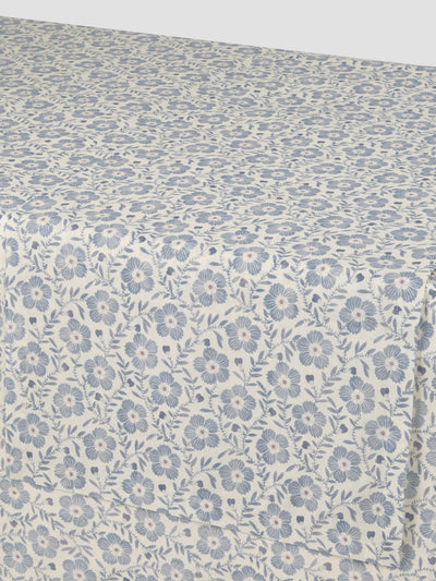 Floral patterned fabric with small blue flowers on a light background