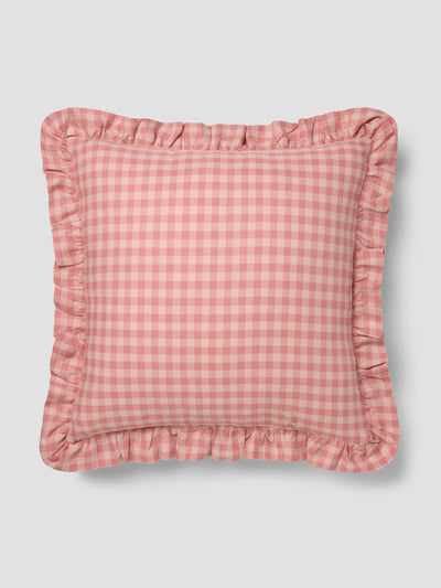Pink gingham cushion with frill edge on a grey background