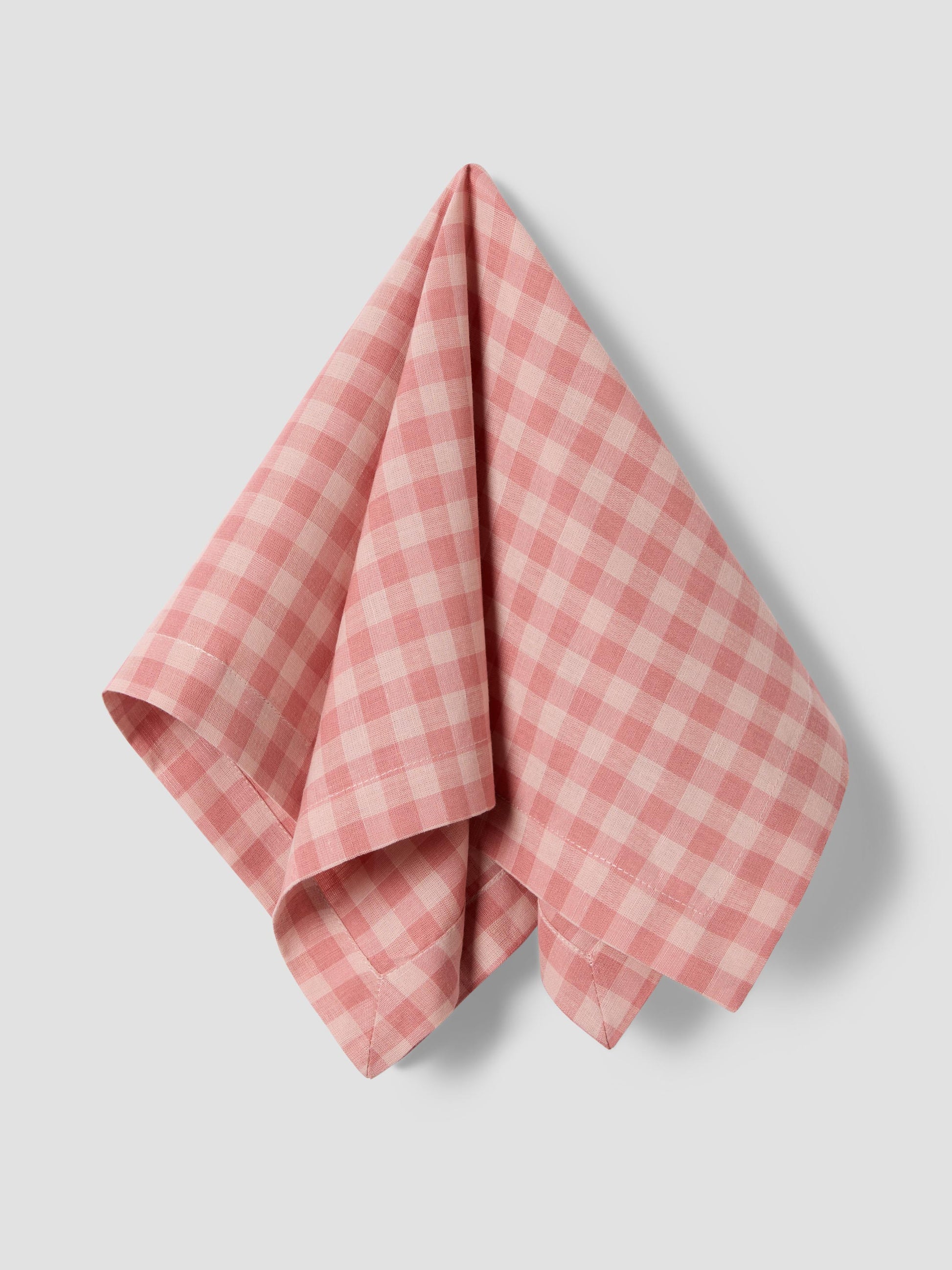 Pink checkered napkin on a light gray background