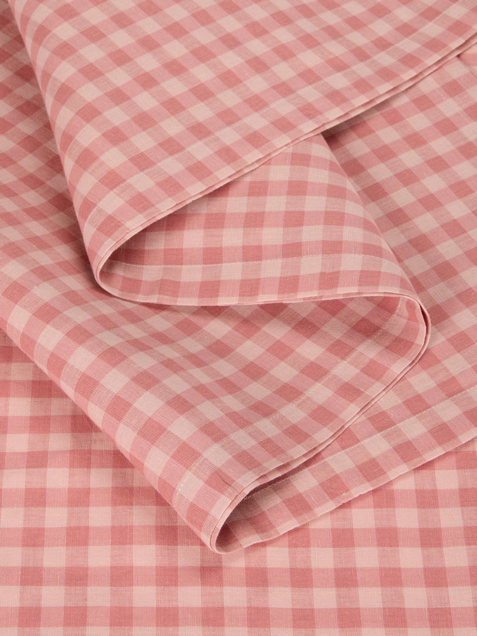 Pink and white checkered fabric with a folded edge