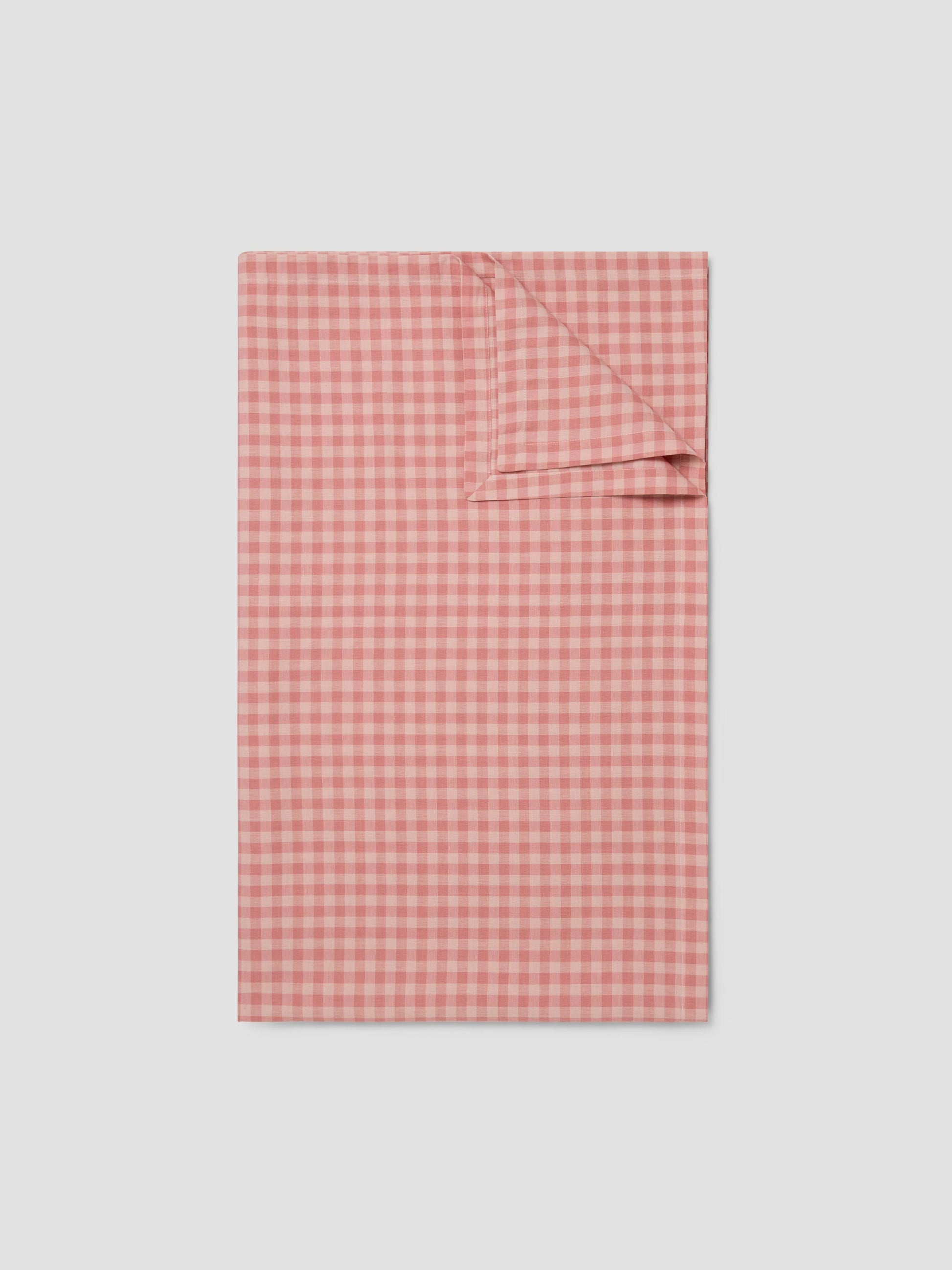 Red and white checkered fabric on a light gray background