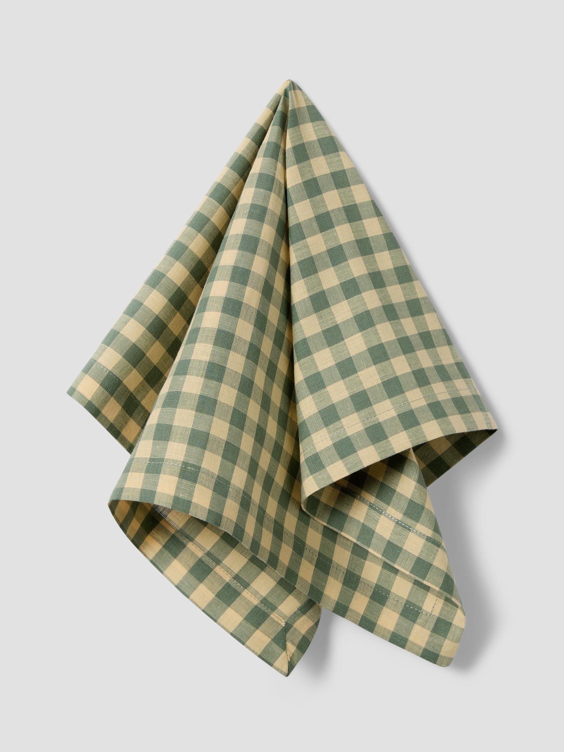 Green and yellow checkered towel on a light gray background