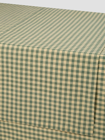 Green and beige checkered fabric on a white background