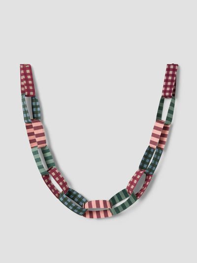 A chunky chain-link fabric garland featuring alternating rectangular links with gingham and striped patterns in burgundy, sage green, and pink, displayed against a neutral light gray background.
