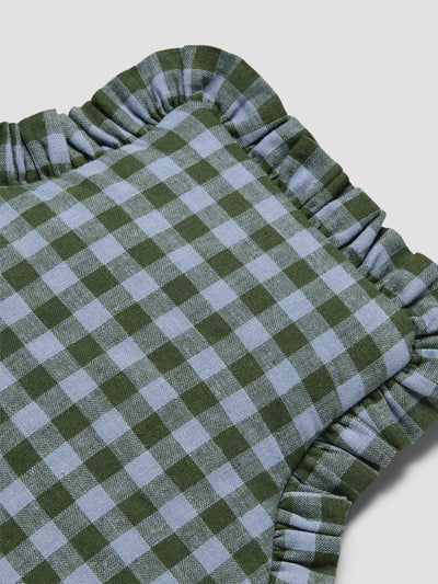 A close-up of a green and light blue gingham check hot water bottle cover with a ruffled edge, shown on a light gray background.