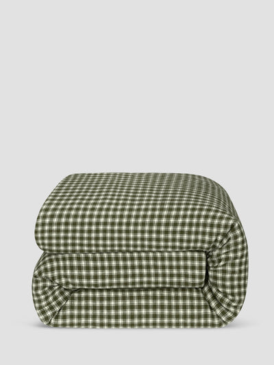 A folded green and white gingham checkered comforter, shown against a solid light gray background.