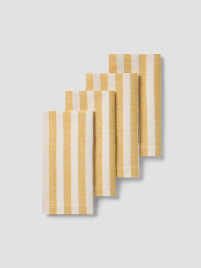 Set of four rectangular napkins with yellow and white striped pattern on a light gray background