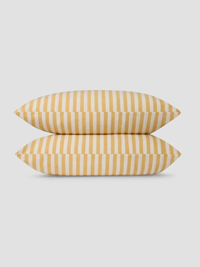 Two yellow striped pillows on a light gray background
