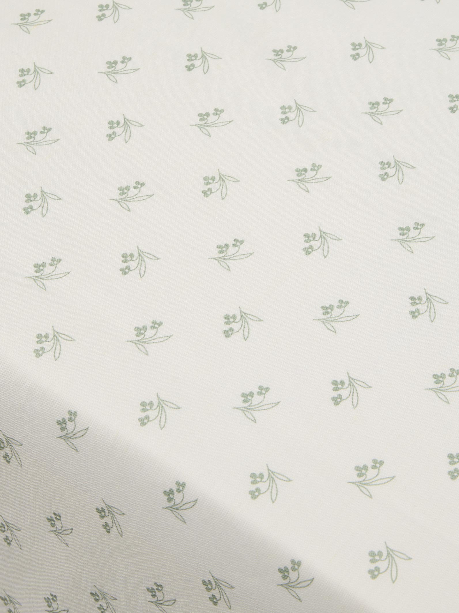 Pattern of small green leaves on a white background