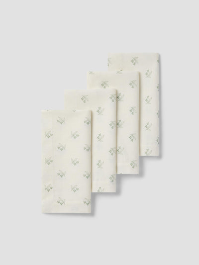 Set of three folded towels with a subtle green floral pattern on a light gray background