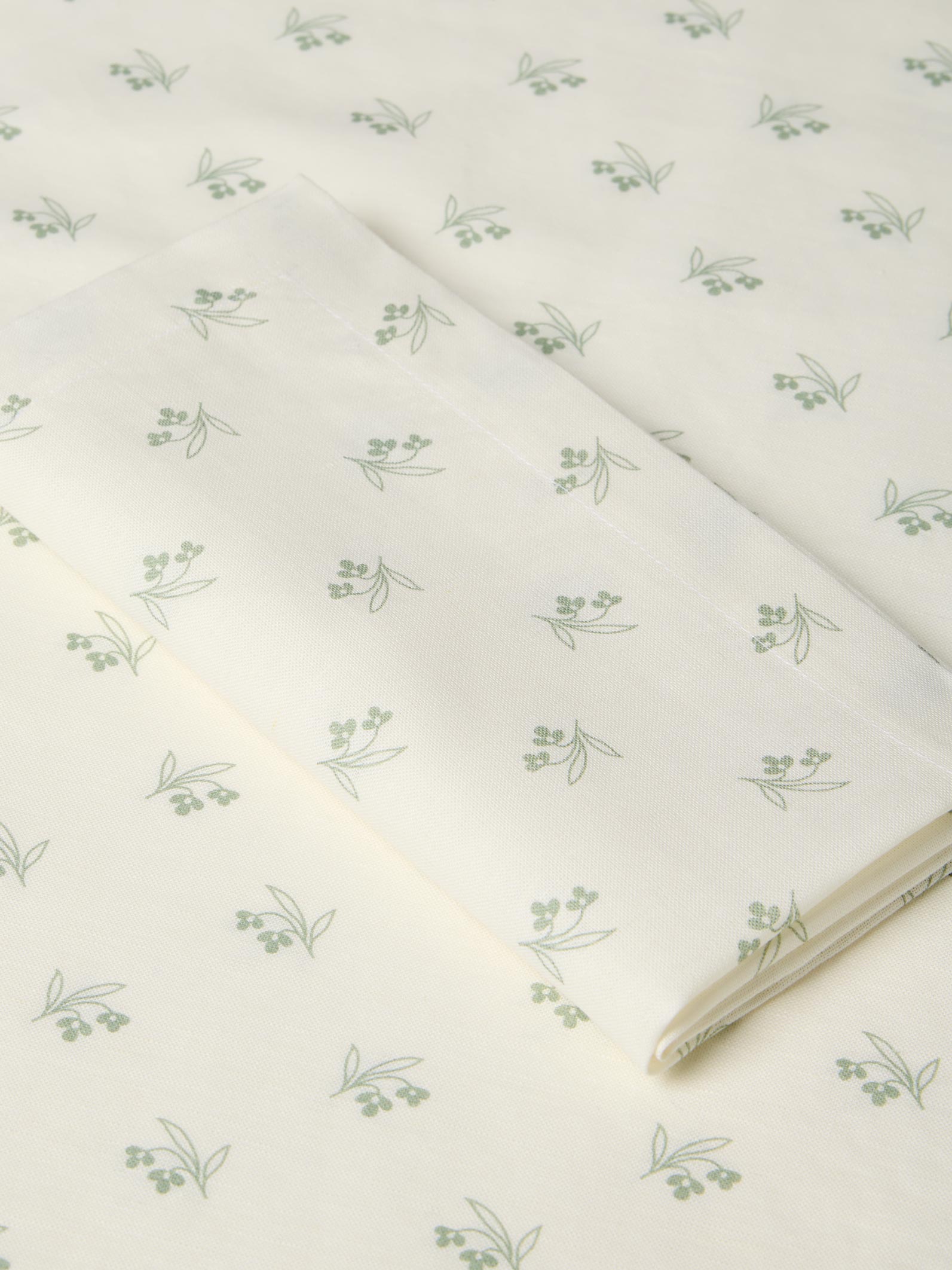 White fabric with green floral pattern