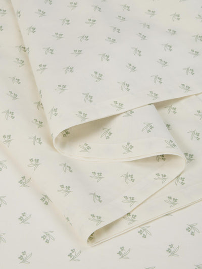 Folded fabric with a subtle floral pattern on a white background