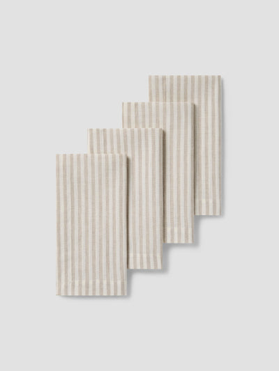 Set of four striped napkins on a light gray background