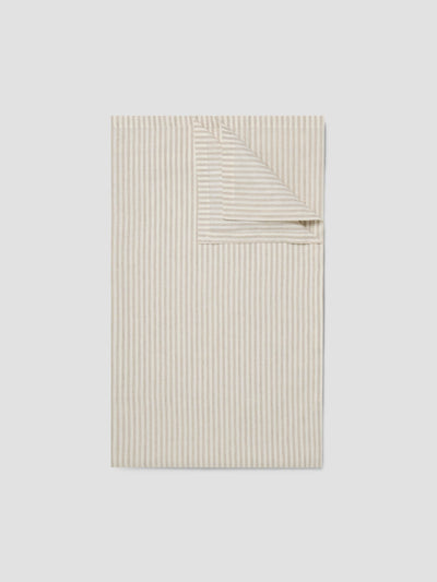 Beige striped fabric on a light gray background