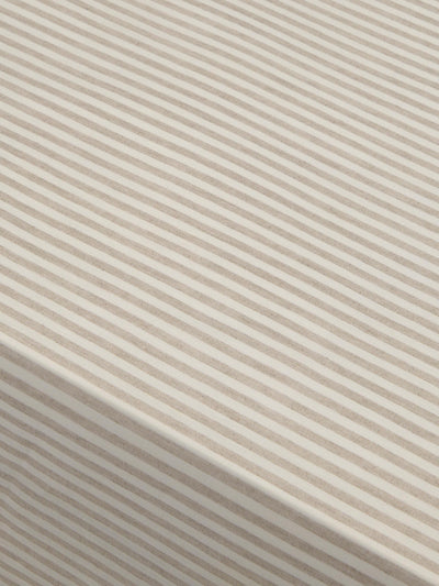 Close-up of beige fabric with subtle stripes