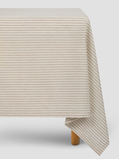 Beige striped tablecloth on a white background