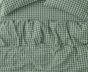 Green and white gingham check bedding set including a comforter and two matching pillowcases, shown in a close-up flat-lay view.