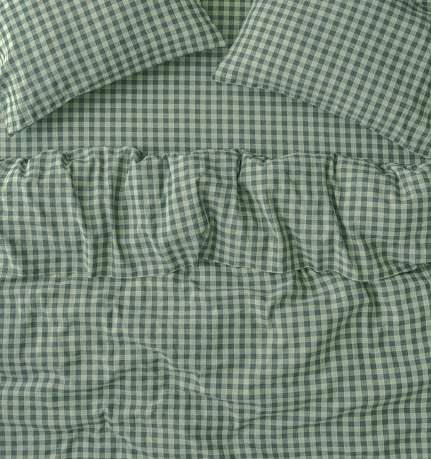 Green and white gingham check bedding set including a comforter and two matching pillowcases, shown in a close-up flat-lay view.