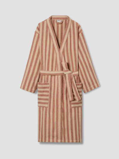 A striped bathrobe with a warm brown and beige vertical pattern, featuring a tie belt and front patch pockets, displayed against a light gray background.
