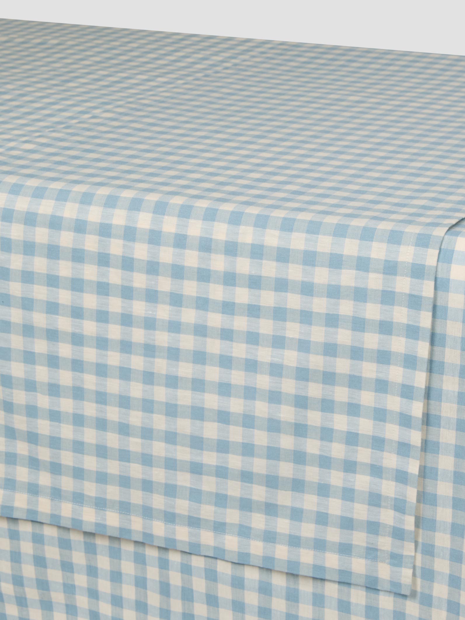 Blue and white checkered fabric sheet on a table
