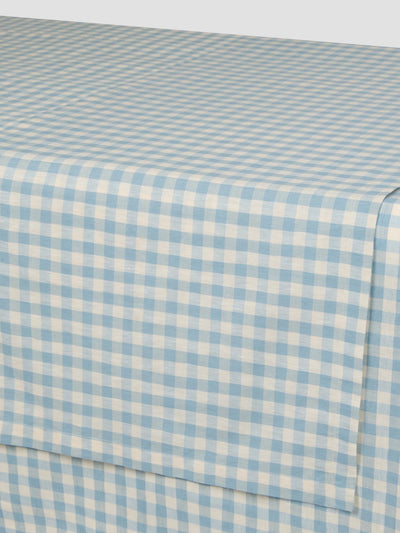 Blue and white checkered fabric sheet on a table