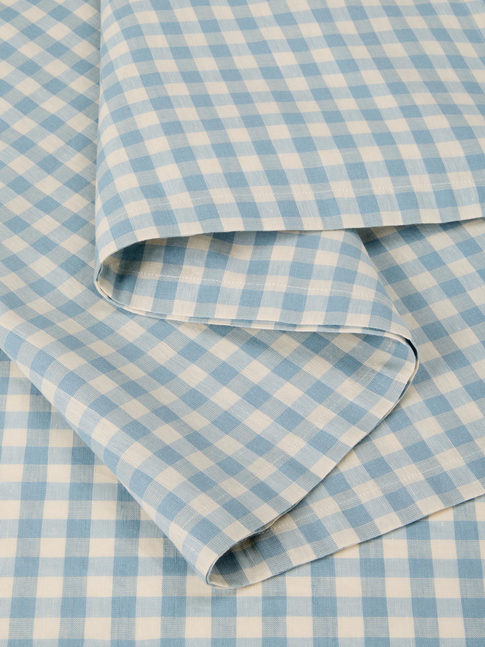 Blue and white checkered fabric with a folded edge