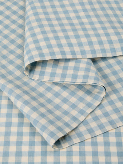 Blue and white checkered fabric with a folded edge