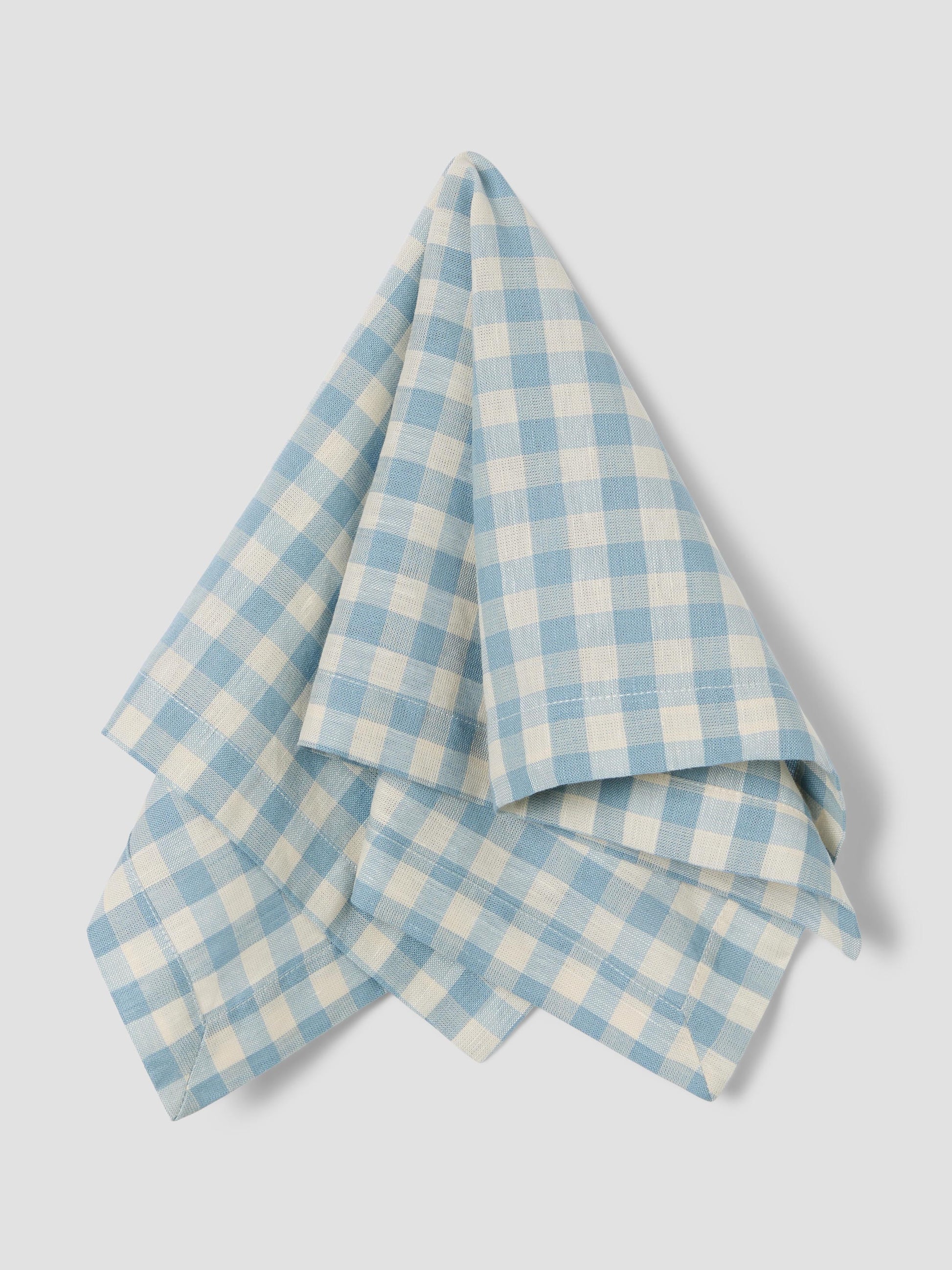 Blue and white checkered napkin on a light gray background