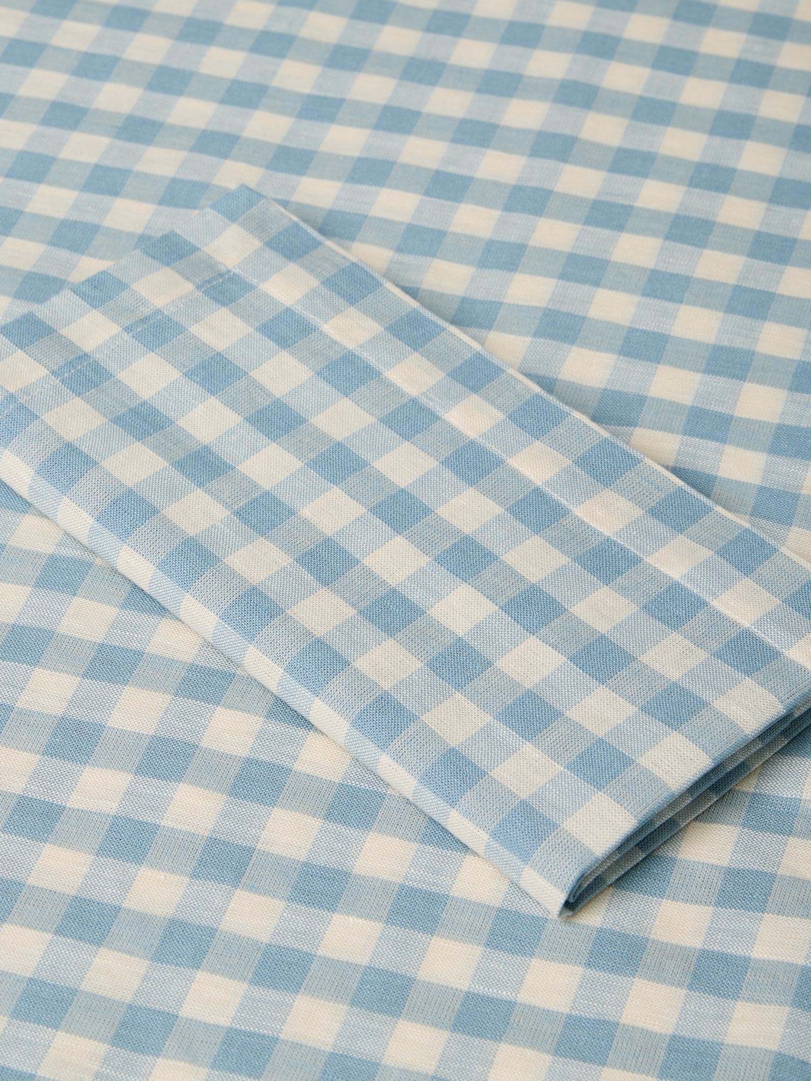 Blue and white checkered fabric with a folded edge