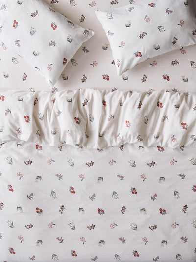 White bedding set with floral print. Featuring duvet, pillows and fitted sheet. 