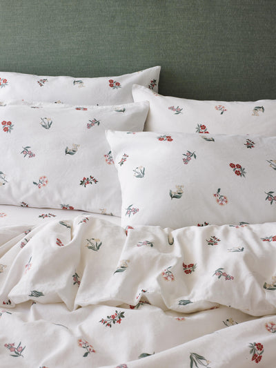 A bedding set with pillows and a duvet cover with a subtle floral print.