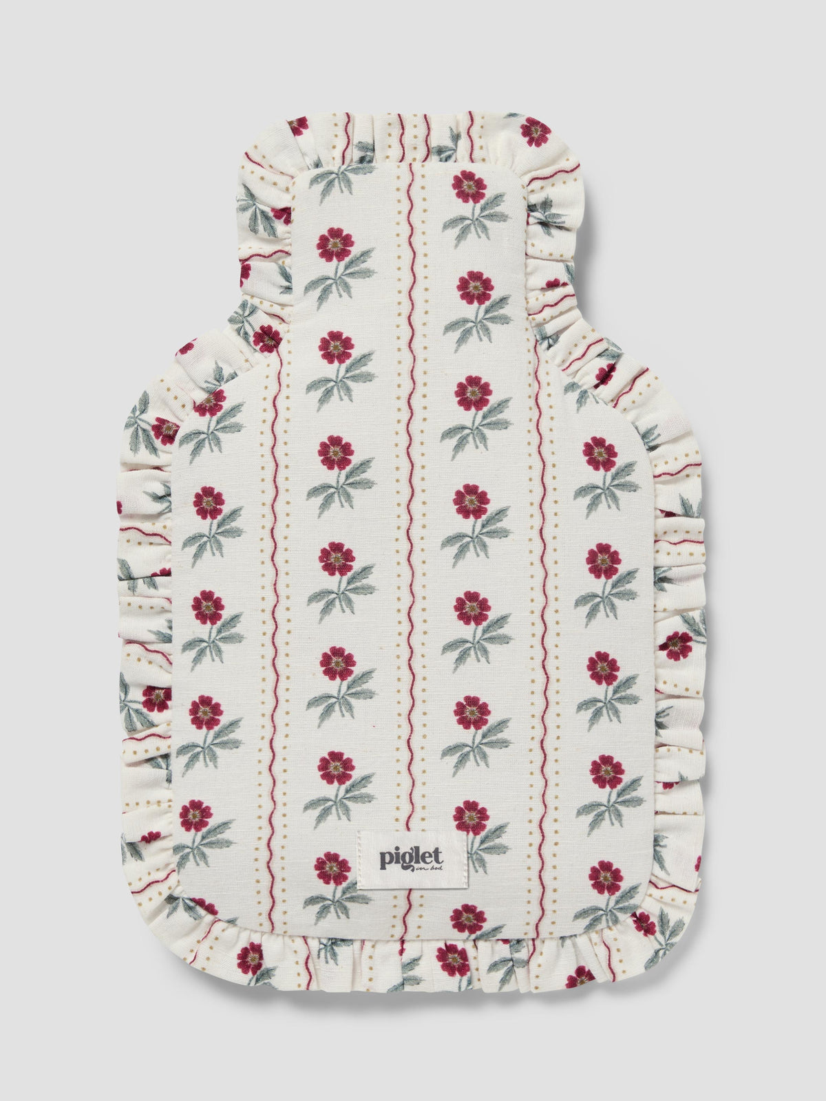 A hot water bottle cover featuring an off-white background with vertical stripes of red flowers and green leaves, finished with a ruffled edge.
